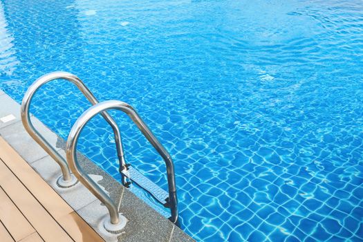 sunshine and clear water of swimming pool