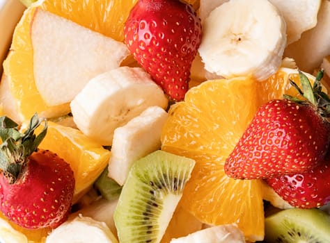 Healthy food. Bowl of fresh mixed fruit salad top view