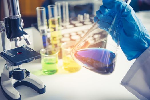  Equipment and science experiments oil pouring scientist with test tube yellow making research in laboratory.