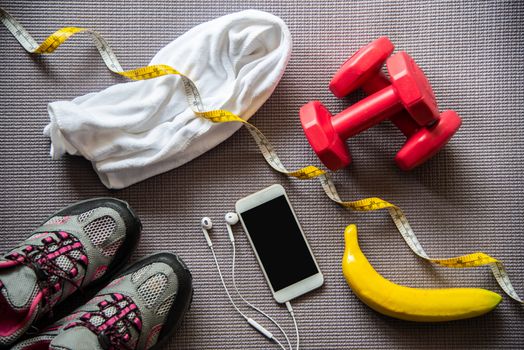 fitness concept with Exercise Equipment on wooden background.