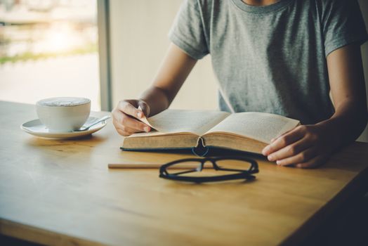 woman sitting in a room reading a book