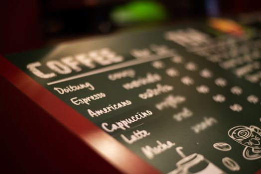 Coffee signs in the shop for customers to order.