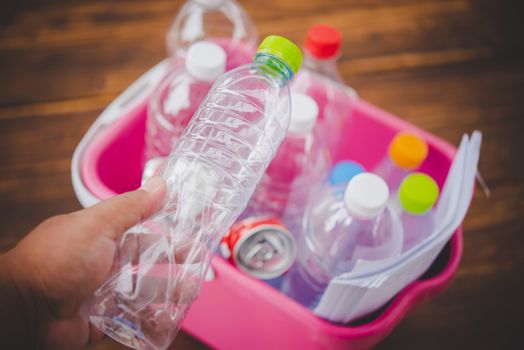 Hands holding bottles for recycling, green concept