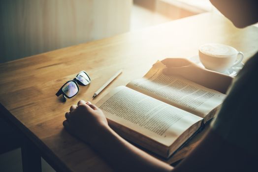 woman sitting in a room reading a book