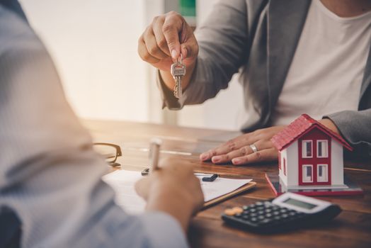 House signers signing signature loan document to home ownership with real estate agents ownership. Mortgage and real estate property investment, home insurance