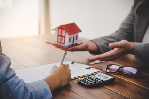 House signers signing signature loan document to home ownership with real estate agents ownership. Mortgage and real estate property investment, home insurance