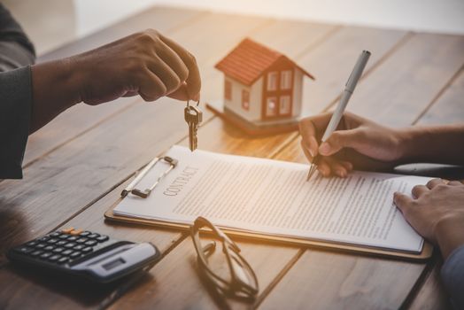 House signers signing signature loan document to home ownership with real estate agents ownership. Mortgage and real estate property investment, home insurance