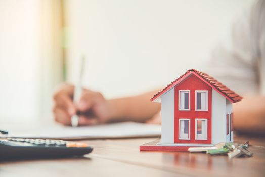 Close up hand  signing signature loan document to home ownership. Mortgage and real estate property investment, home insurance ,security 