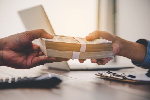 Hand giving money - United States Dollars . Hand receiving money from businessman