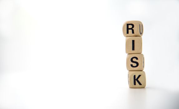 wooden block with the word "RISK". Concept risk management