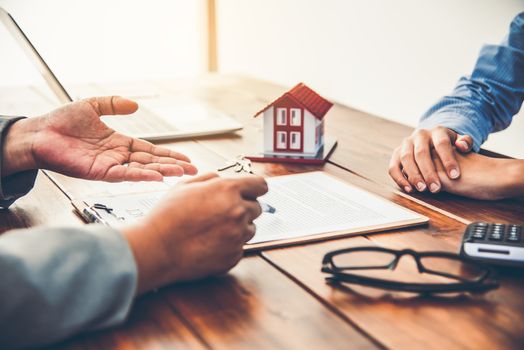 House signers signing signature loan document to home ownership with real estate agents ownership. Mortgage and real estate property investment, home insurance