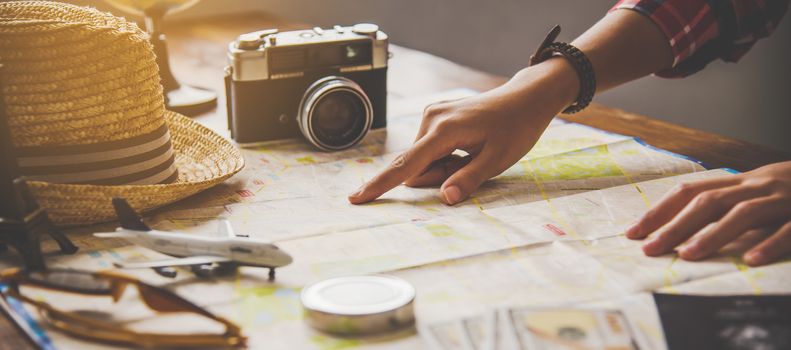 Travelers are planning a trip by searching the route on the map and searching for information on the internet.