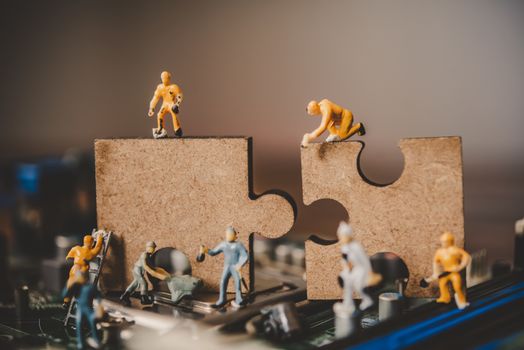 
Miniature people or small figure worker on puzzles to connect. Ideas about building a business network concept.