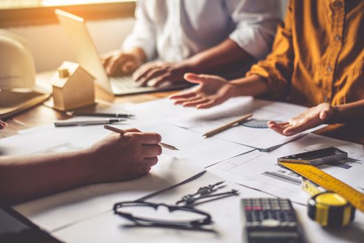 Team of engineers working together in a architect office.
