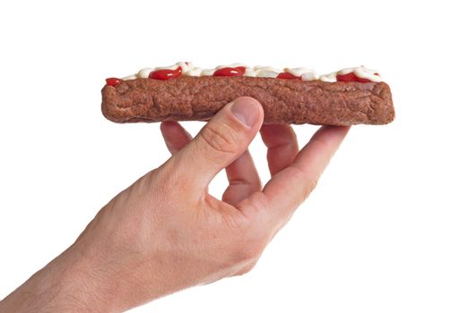 One frikadel with ketchup, mayonnaise on chopped onions, a Dutch fast food snack called 'frikadel speciaal', the Netherlands