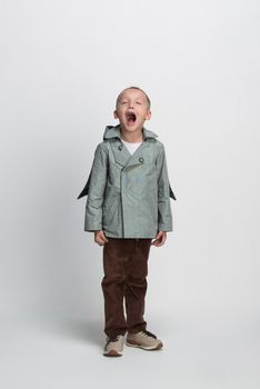 screaming little boy on white background, studio shooting