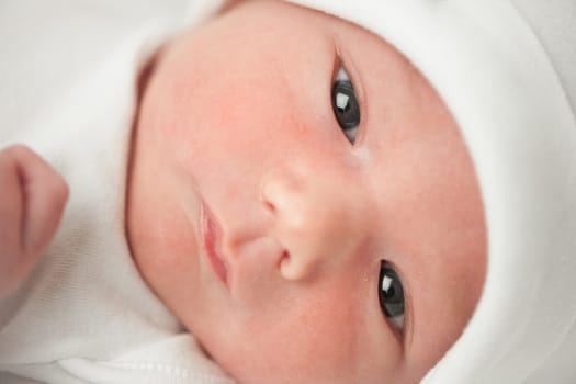 face baby in a white hat on a white background