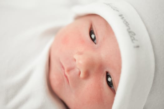 face baby in a white hat on a white background