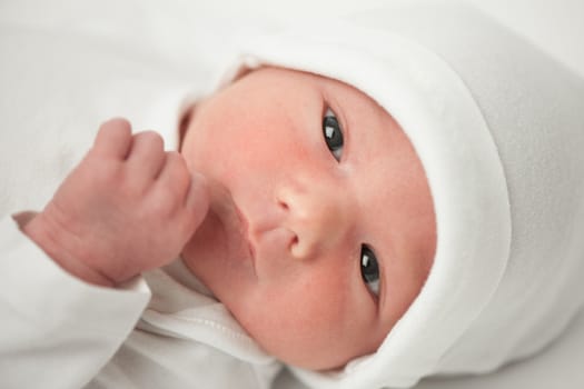 face baby in a white hat on a white background