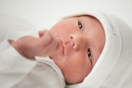 face baby in a white hat on a white background