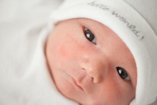 face baby in a white hat on a white background