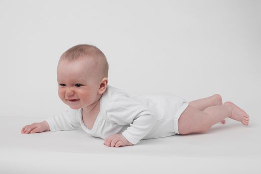 baby on a white background in a white pajamas