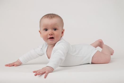 baby on a white background in a white pajamas