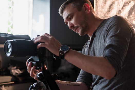 a young photographer in the Studio configures the camera