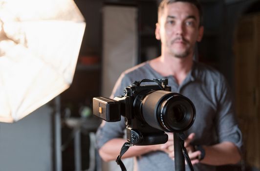 close-up of the camera on the background of the photographer and lighting equipment