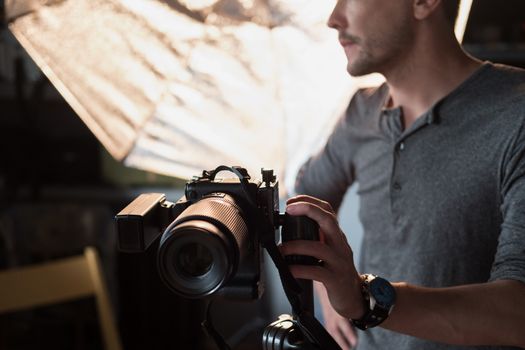 closeup of the camera on the background lighting and the photographer