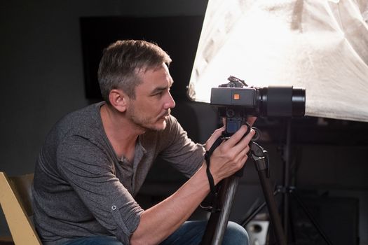 young man sitting on a chair photographed in the Studio