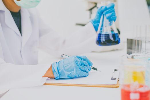  The scientist is recording the scientific value on a note. In an experiment in the LAP room