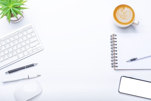 Top view with working desk with laptop,cellphone,notebook pencil coffee cup and eyeglasses in the office. 