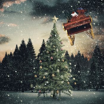 Santa flying his sleigh against christmas tree in snowy landscape