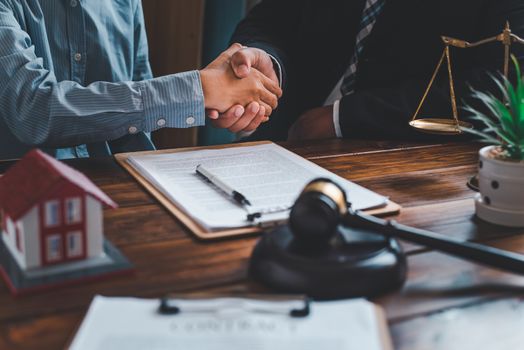 Holding hands after making an agreement with both parties after advising them on the dispute or agreement on home and real estate.