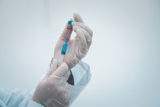 close-up doctor with syringe ready for injection of vaccine to patient. Vaccination concept.