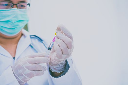 Doctor with syringe ready for injection of vaccine to patient. Vaccination concept.