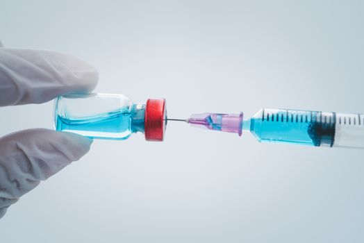 close-up doctor with syringe ready for injection of vaccine to patient. Vaccination concept.