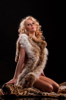 Young beautiful naked woman in fur