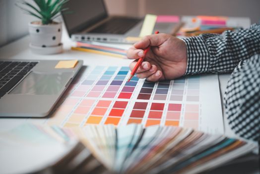 

The graphic designer creative team is currently working on the design and color selection on the guide color for advertising design.