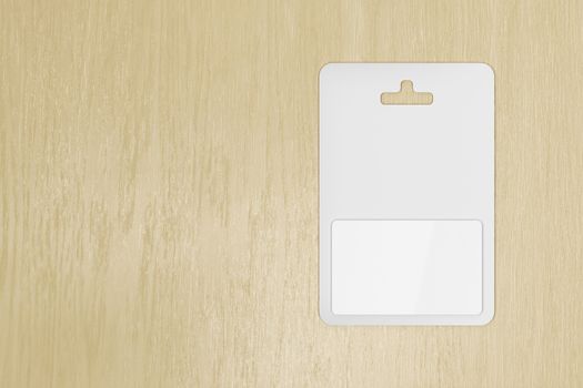 Blank gift card in blister packaging on wooden table, top view