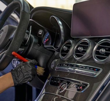 manual cleaning of the interior of luxury cars in the garage.