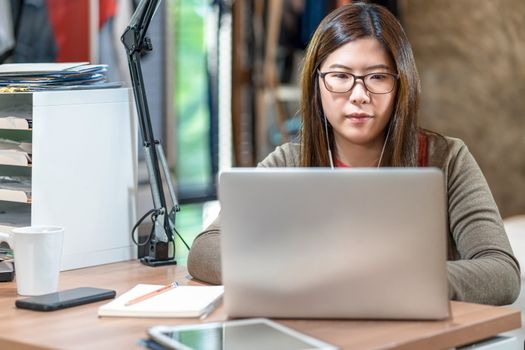 Asian business woman using technology laptop and working from home in bedroom, video conference and education,startups and business owner,lifestyle occupation,social distancing and self responsibility