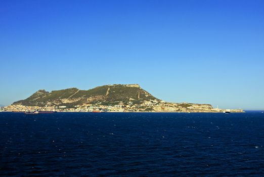 Gibraltar is a British territory located to the south of the Iberian Peninsula at the entrance to the Mediterranean Sea.  The land is one of the most southerly points in Europe.