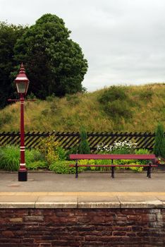 A traditional lamp and seat on the platform of Lazonby station on the historic Settle to Carlisle railway in northern England.
