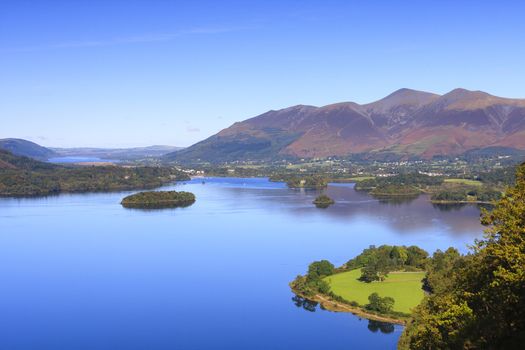 A view across Derwentwater in the English Lake District National Park to the town of Keswick and beyond is Skiddaw.  Skiddaw is the fourth highest mountain in England.