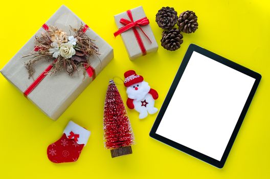 Technology for sending greetings and special gifts during the Christmas season on yellow paper floor 