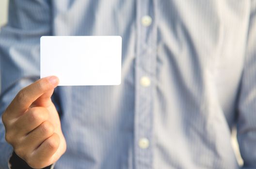 Close Up man holding white business card 