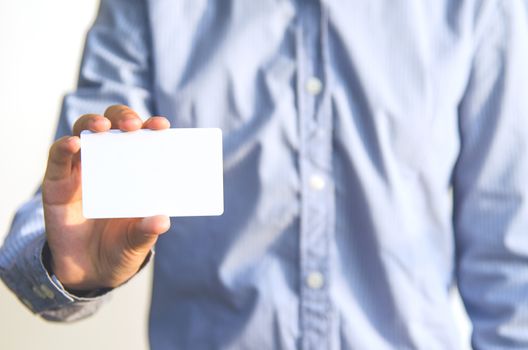 Close Up man holding white business card 