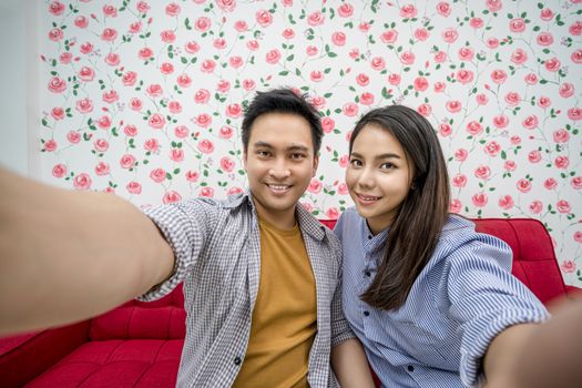 Asian Vlogger of married couple taking video and stream live to attendee via mobile phone by social media channel, say hello and bye bye, lovers and valentine, vlog and influencer freelance concept